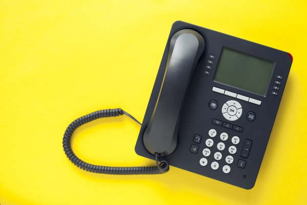 riingcentral voip service black voip phone yellow background